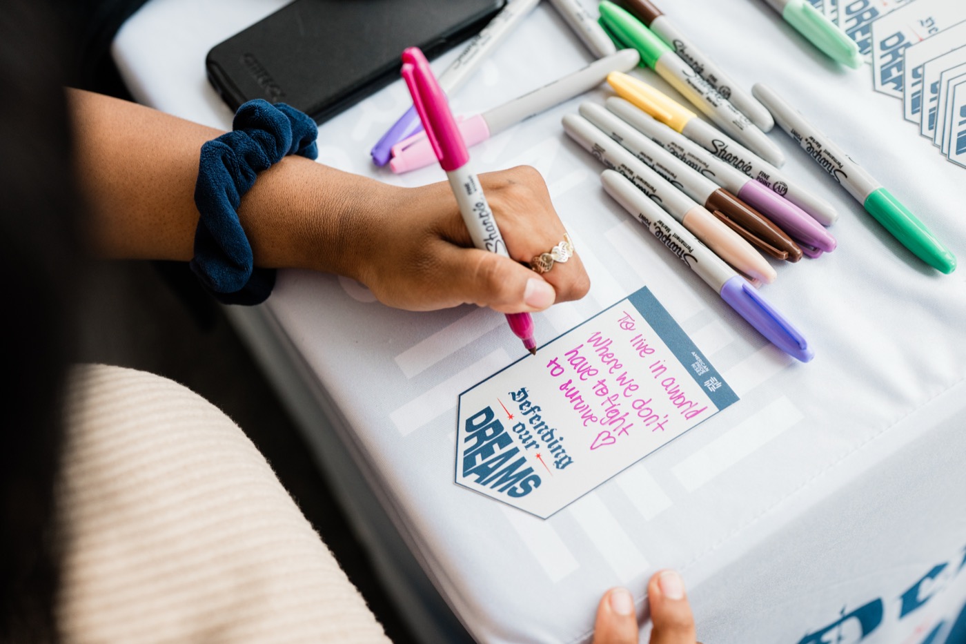 Defending Our Dreams tour resource table with campaign materials